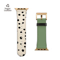 a watch strap with black dots on a white background