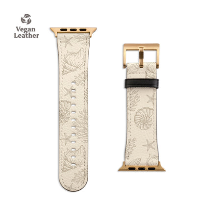 a white watch strap with a gold buckle