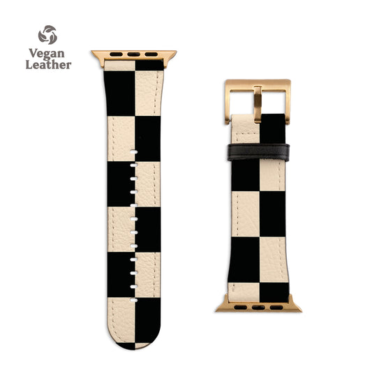 a black and white watch strap with a gold buckle