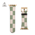 a green and white watch strap with a gold buckle
