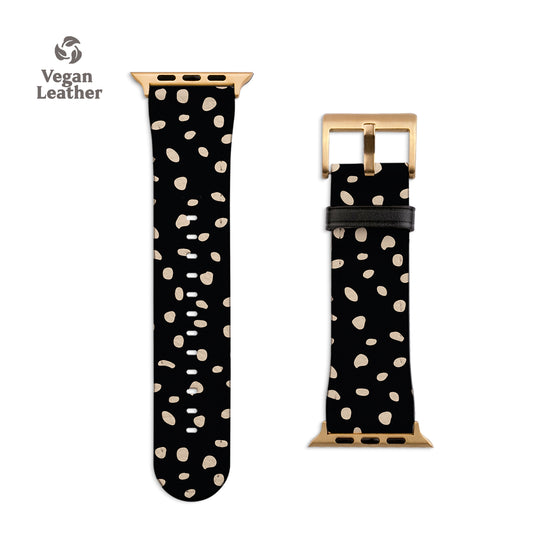 a black and gold watch strap with white polka dots